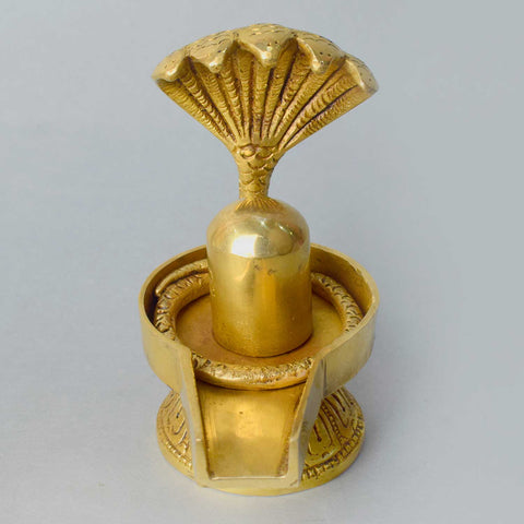 4.7-inch handcrafted brass Shivling with Sheshnaag, intricately crafted to symbolize Lord Shiva's divine presence and protection. The Sheshnaag wraps around the Shivling, representing spiritual power and purification. Ideal for worship, spiritual spaces, or home décor. India’s Largest Pooja Accessories Brand – www.satvikworld.com