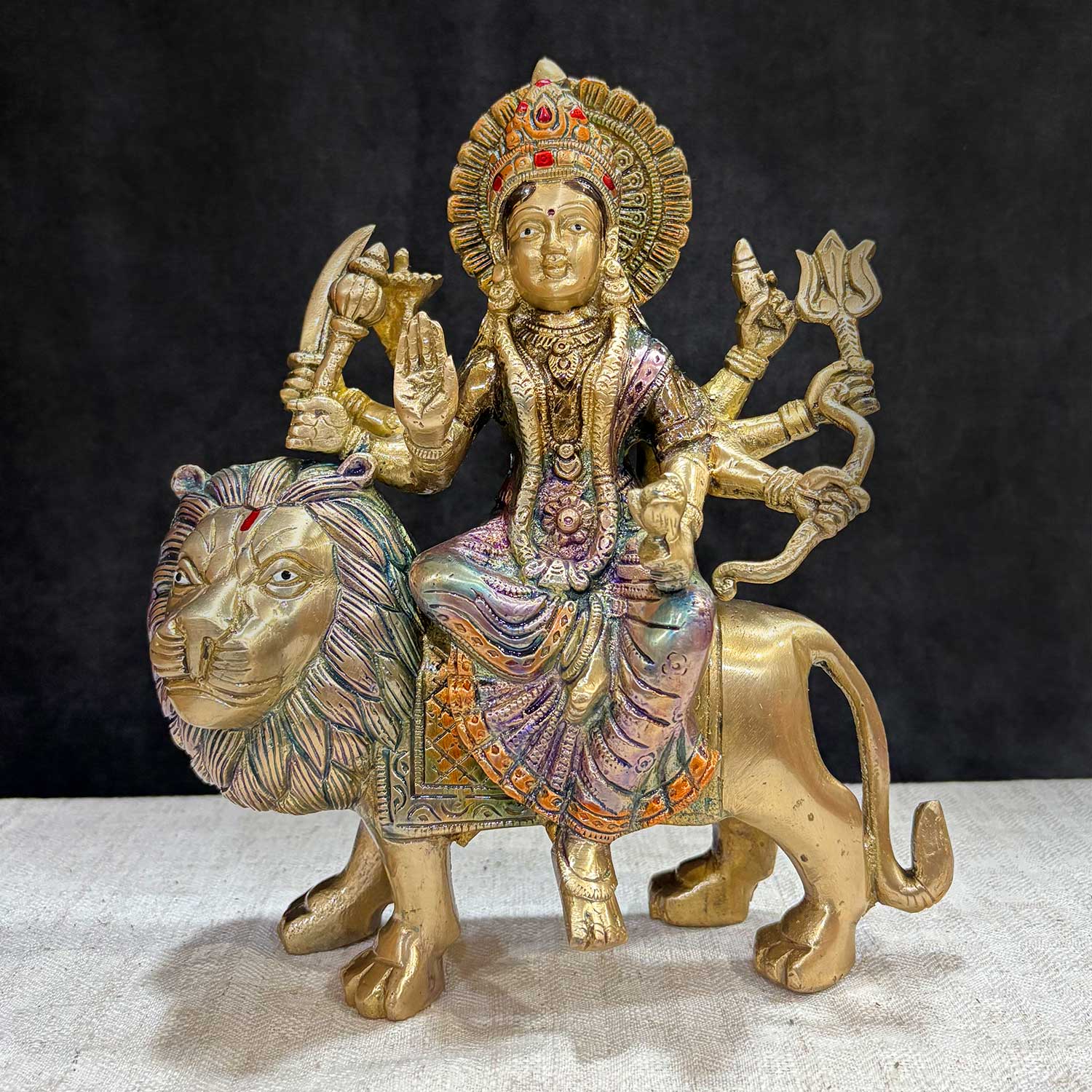 9 inch Exquisite Brass Maa Durga Idol with 8 Arms – Seated on Lion, A Divine Representation of Goddess Durga in Her Powerful Form, Symbolizing Strength, Protection, and Victory Over Evil. This Intricately Designed Brass Idol Features Maa Durga with 8 Arms, Mounted on a Lion, and is Perfect for Spiritual Worship and Home Temple Decor. India’s Largest Pooja Accessories Brand – www.satvikworld.com