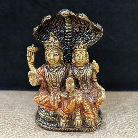 5-inch brass Vishnu Laxmi idol, with Lord Vishnu and Goddess Laxmi seated together, featuring Sheshnag at the back as a symbol of protection and divine energy. Perfect for pooja rooms and spiritual spaces. India’s Largest Pooja Accessories Brand – www.satvikworld.com