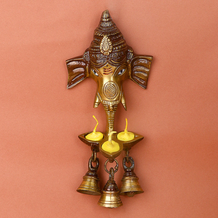 Brass Ganesh wall hanging with bell and diya, intricately designed to bring spiritual energy and blessings. Ideal for pooja rooms, entrances, or as a decorative piece. India’s Largest Pooja Accessories Brand – www.satvikworld.com
