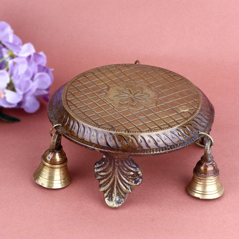 Decorative brass chowki with bells, intricately crafted to enhance the elegance of your pooja setup. Adorned with detailed carvings and hanging bells, ideal for placing idols or diya during rituals. India’s Largest Pooja Accessories Brand – www.satvikworld.com